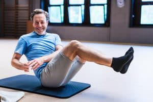 man doing Pilates matwork