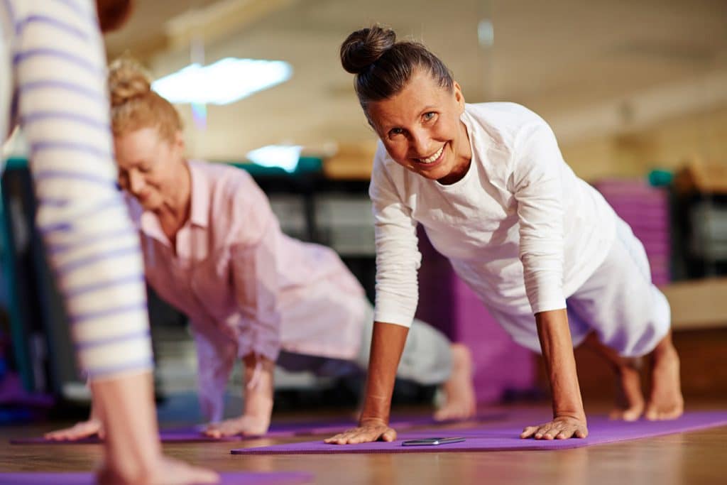 women over 50 in pilates mat class