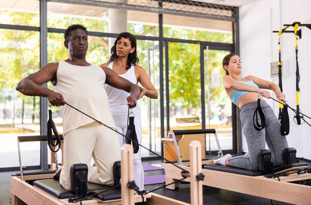 man doing Pilates on reformer